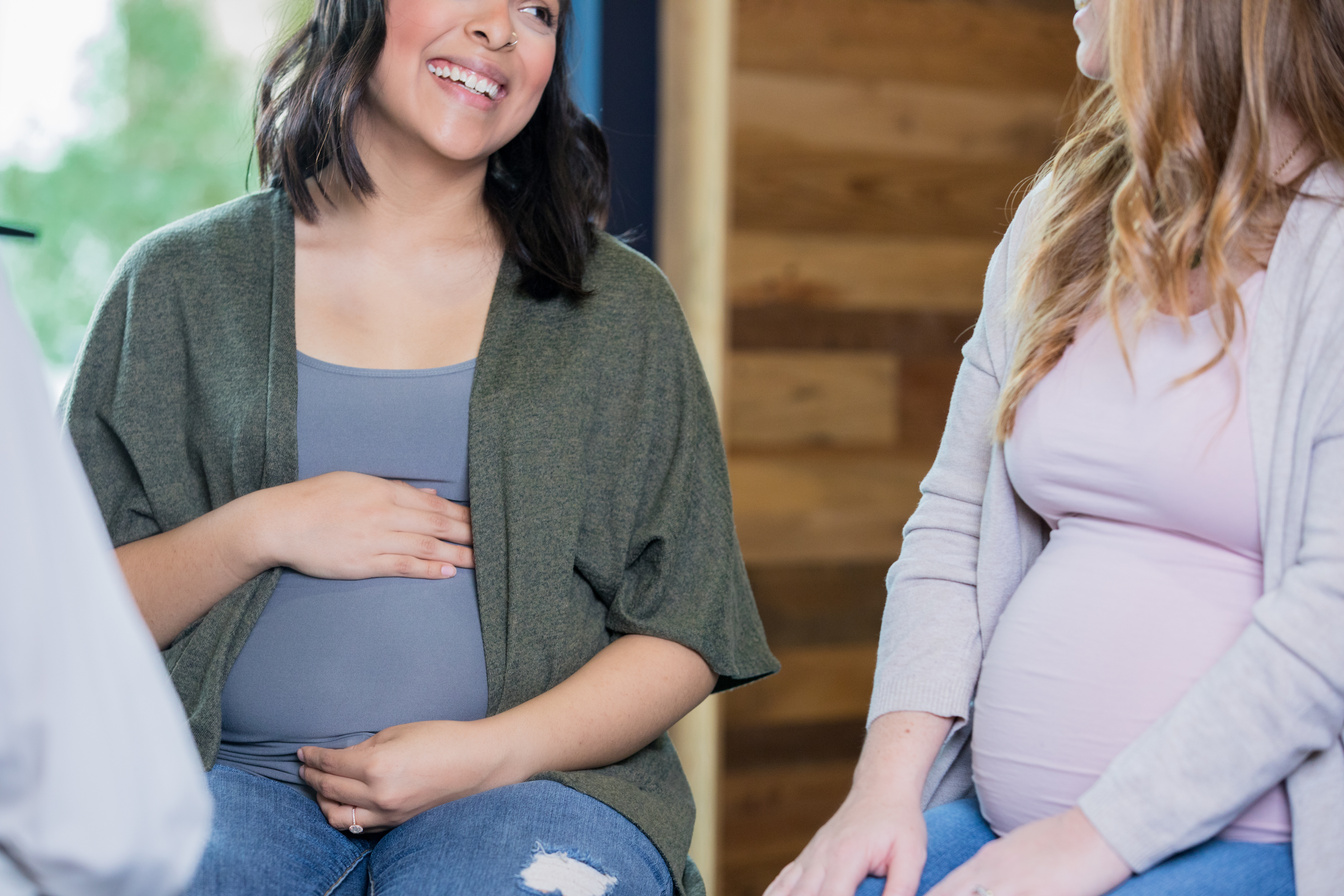 Diverse women supporting each other during pregnancy childbirth class